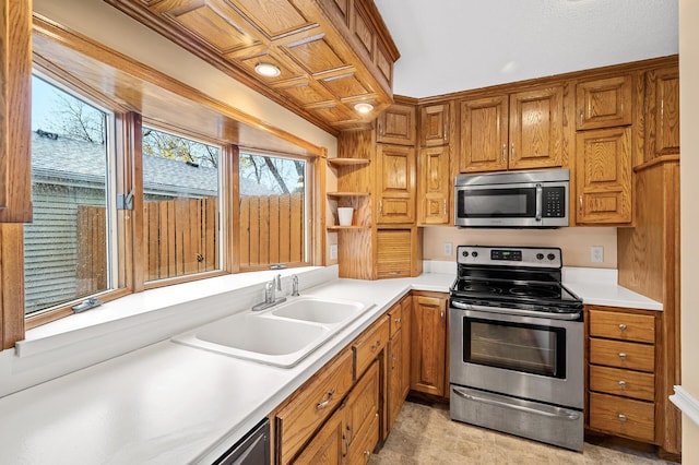 kitchen featuring appliances with stainless steel finishes, sink, and ornamental molding