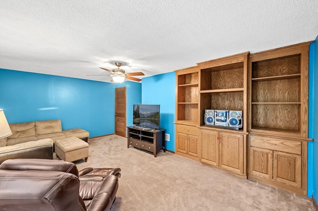 carpeted living room with a textured ceiling and ceiling fan