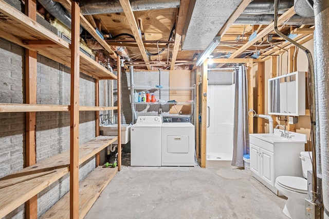 basement featuring sink and independent washer and dryer