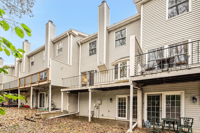 back of property with a patio area and a balcony