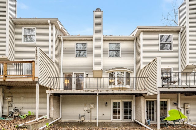 rear view of property with a balcony