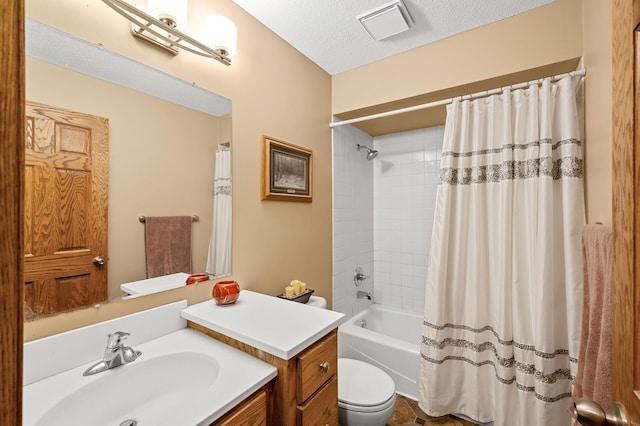 full bathroom with vanity, shower / tub combo, a textured ceiling, and toilet