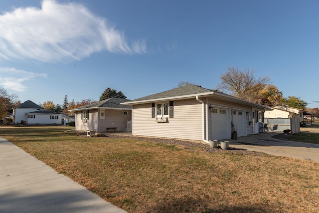 ranch-style house featuring a front yard and a garage