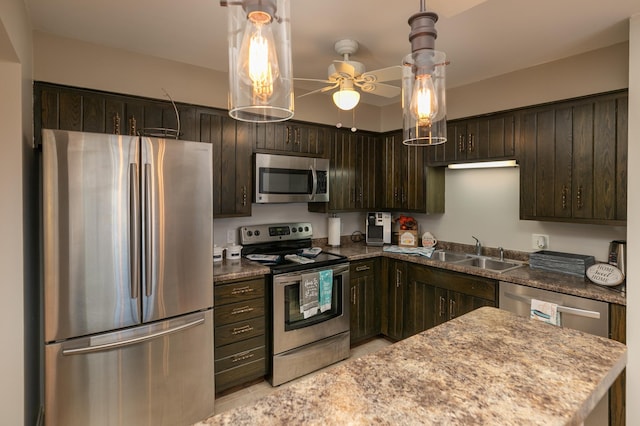 317 6th Ave SW Unit 501, Rochester, MN 55902 - kitchen with stainless steel appliances, dark brown cabinetry, a sink, a ceiling fan, and hanging light fixtures