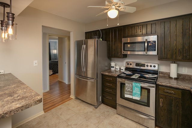 317 6th Ave SW Unit 501, Rochester, MN 55902 - kitchen with stainless steel appliances, ceiling fan, dark brown cabinetry, and baseboards