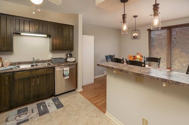 317 6th Ave SW Unit 501, Rochester, MN 55902 - kitchen with stainless steel dishwasher, a sink, dark brown cabinetry, light tile patterned floors, and pendant lighting