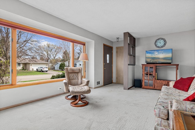 carpeted living room featuring baseboards and visible vents