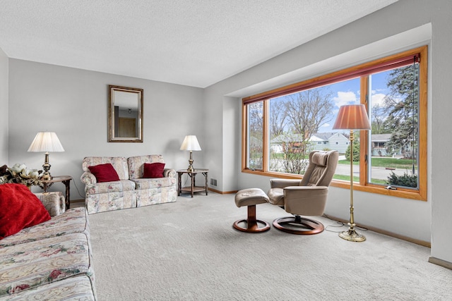 living area with baseboards, carpet flooring, and plenty of natural light