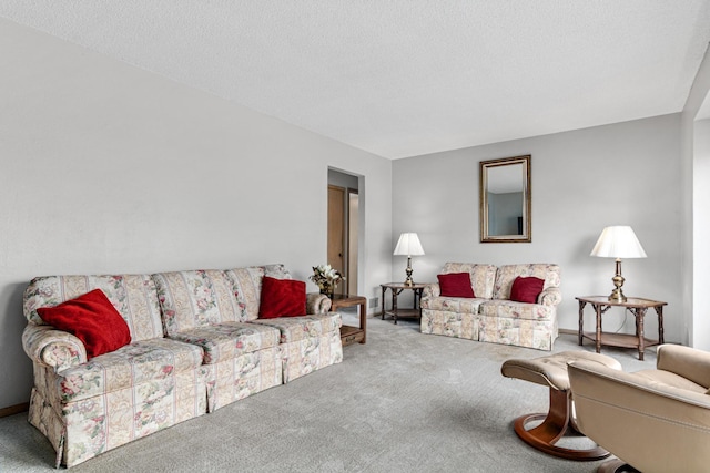 living area with baseboards, a textured ceiling, and carpet flooring