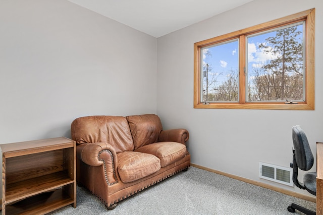 office area featuring baseboards, visible vents, and carpet