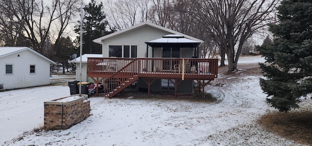 snow covered property featuring a gazebo and a deck