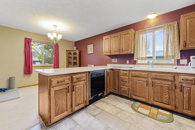 kitchen featuring a wealth of natural light, black dishwasher, kitchen peninsula, and decorative light fixtures