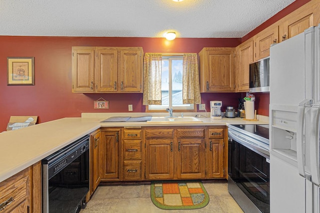 kitchen featuring wine cooler, stainless steel appliances, sink, and a textured ceiling