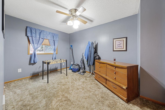 misc room featuring ceiling fan, carpet flooring, and a textured ceiling