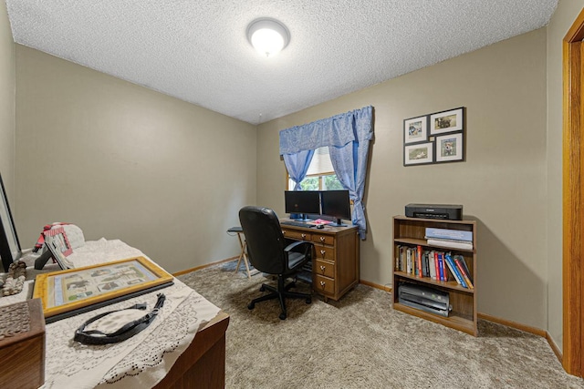 carpeted office with a textured ceiling