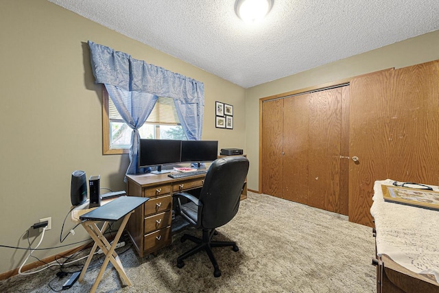 office space with a textured ceiling and dark colored carpet