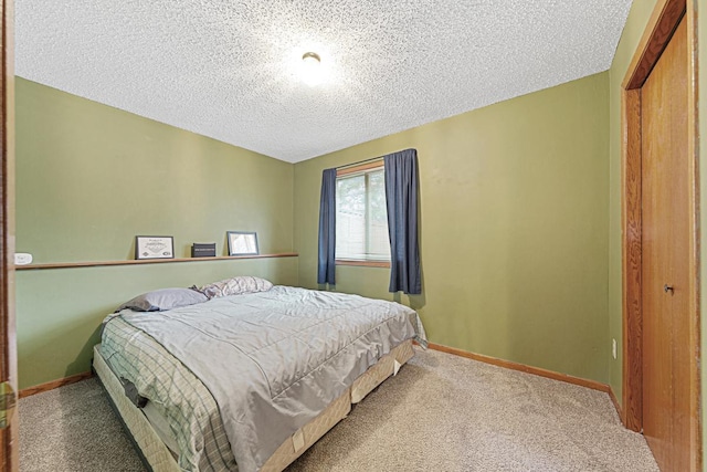 bedroom featuring a closet, a textured ceiling, and carpet flooring