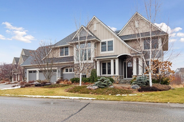 view of front of property featuring a front yard and a garage