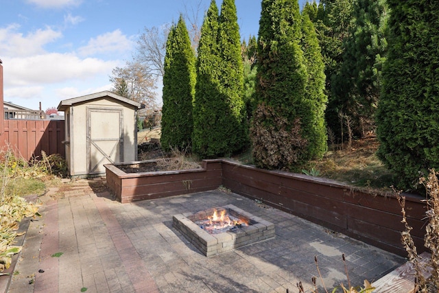 view of patio featuring a storage unit and a fire pit