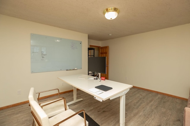 office area with hardwood / wood-style flooring and a textured ceiling