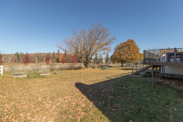 view of yard with a rural view and a wooden deck