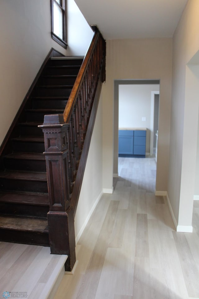 stairway featuring wood-type flooring