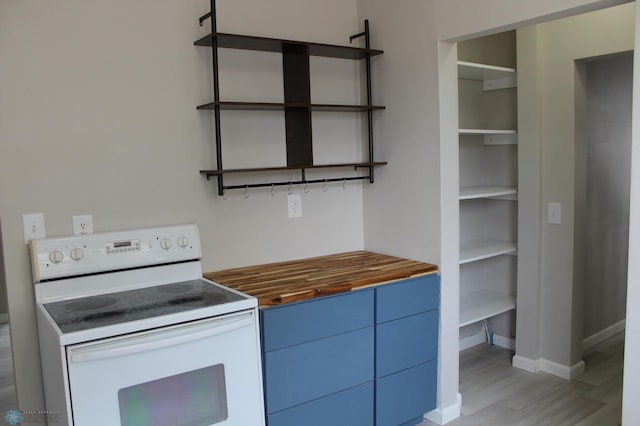 kitchen with wooden counters, blue cabinets, white range with electric cooktop, and light hardwood / wood-style floors