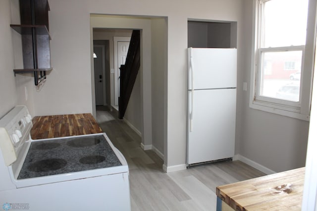 kitchen featuring light hardwood / wood-style flooring and white appliances