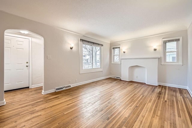 unfurnished living room with plenty of natural light and light wood-type flooring