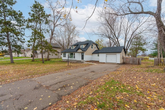 view of front of property with a garage and a front lawn