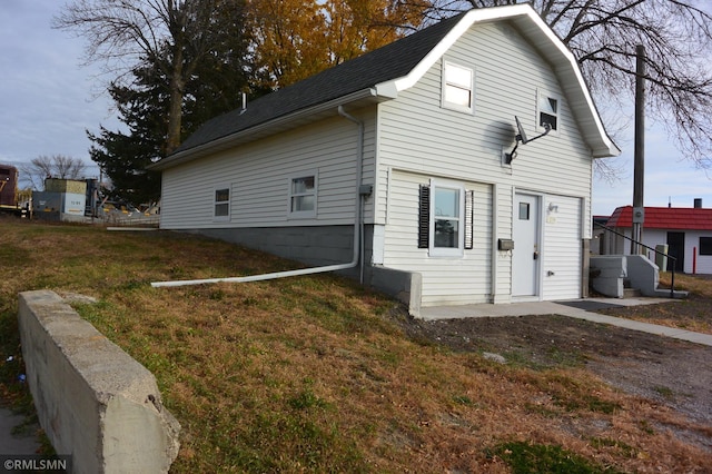 view of side of property with a lawn