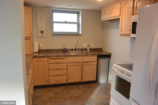 kitchen featuring light brown cabinets, sink, and white appliances