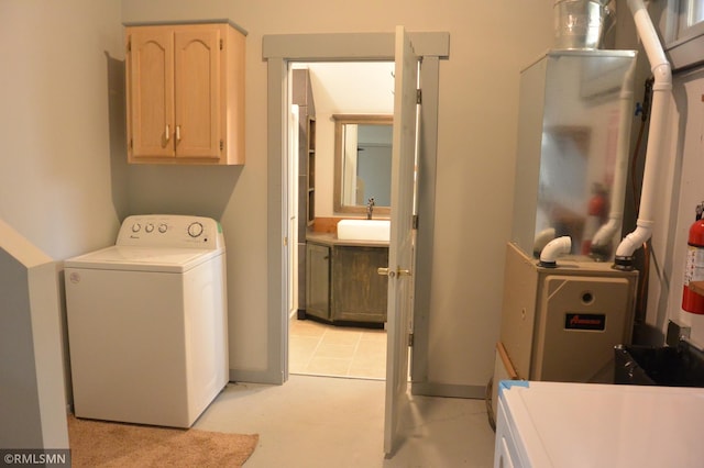 clothes washing area featuring washer / clothes dryer and sink