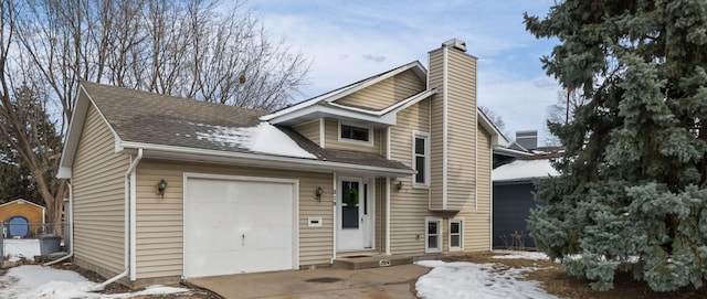 view of front of house featuring a shingled roof, concrete driveway, a chimney, and an attached garage