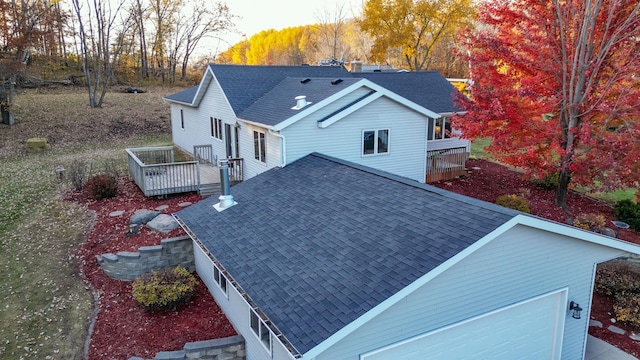 exterior space featuring a wooden deck and a garage