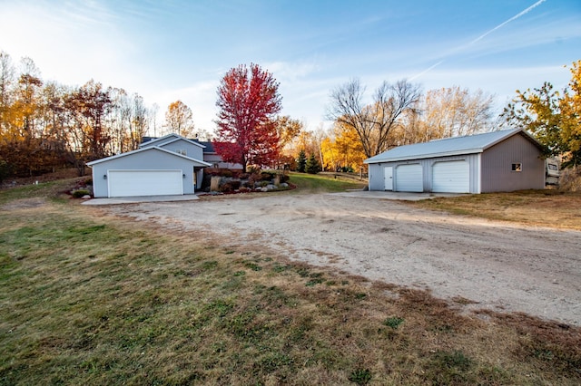 exterior space with a yard, an outbuilding, and a garage