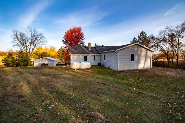 rear view of property with a yard