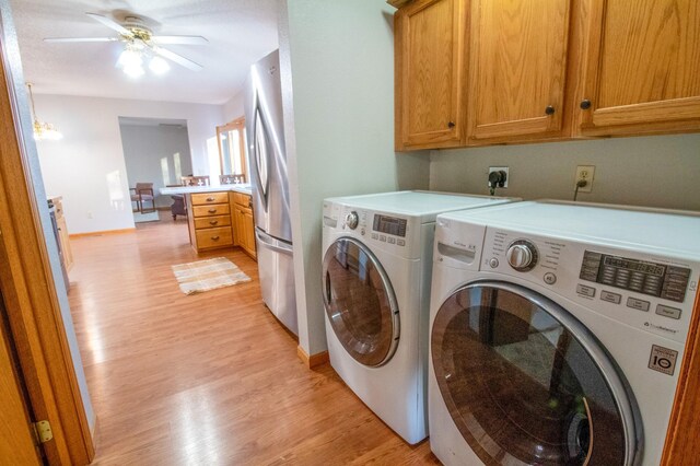 washroom featuring cabinets, light hardwood / wood-style flooring, washer and clothes dryer, and ceiling fan