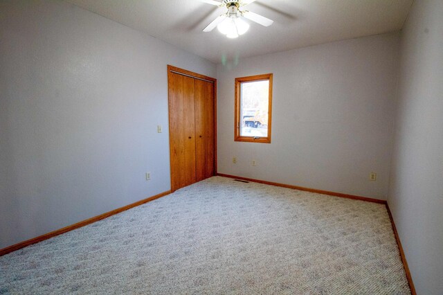 empty room with carpet and ceiling fan