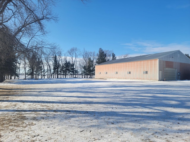 exterior space with a garage and an outbuilding