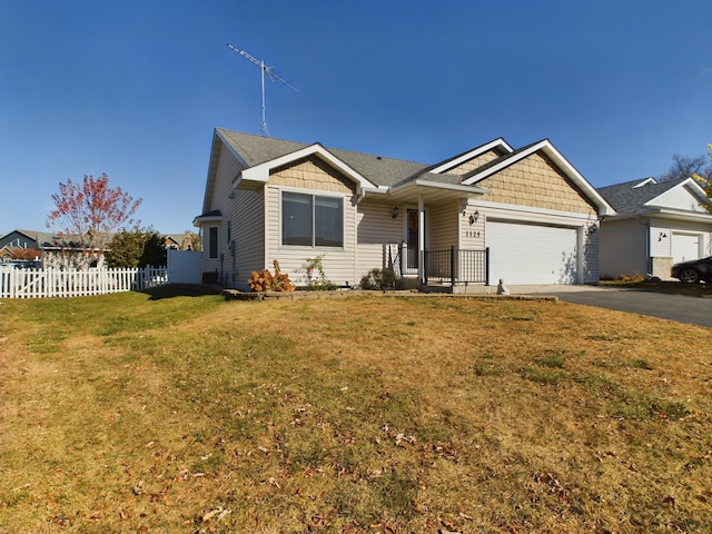 view of front facade with a front yard and a garage