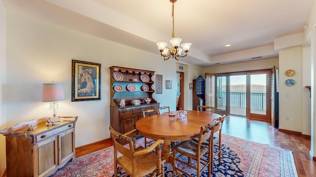 dining room with a notable chandelier and wood-type flooring