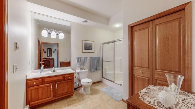 bathroom with vanity, an enclosed shower, and toilet