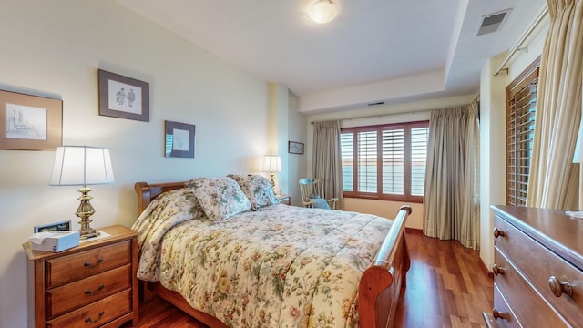 bedroom with dark hardwood / wood-style floors