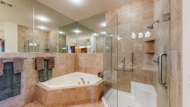 bathroom with tile walls, tile patterned floors, and separate shower and tub