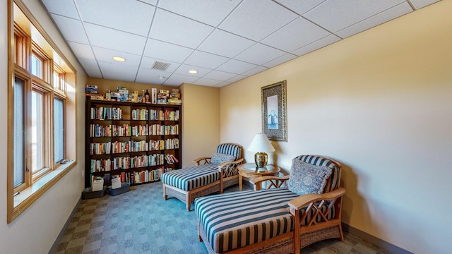 sitting room with a paneled ceiling