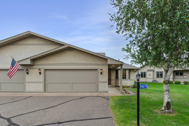 single story home with a front lawn and a garage