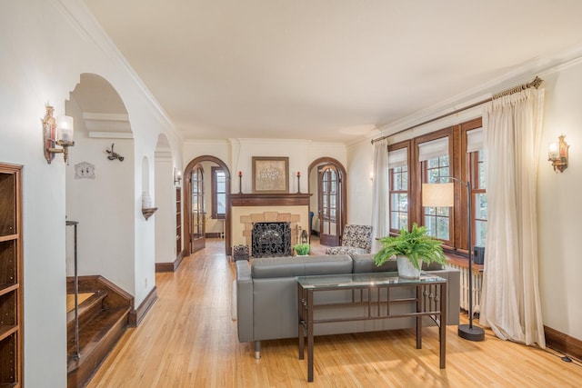 living room featuring light hardwood / wood-style floors and ornamental molding