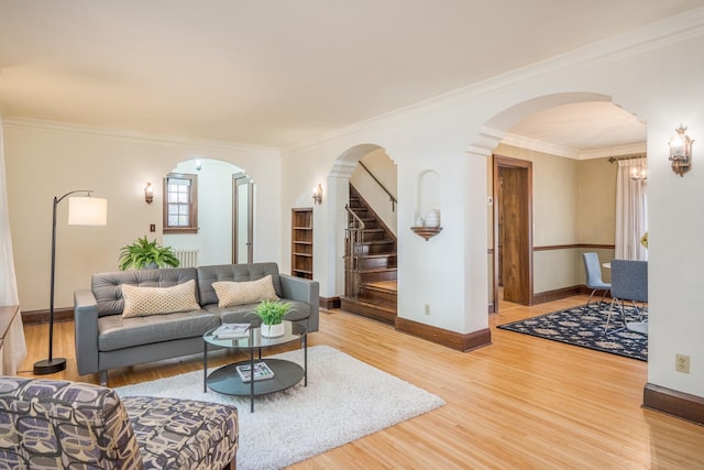 living room with hardwood / wood-style floors and crown molding