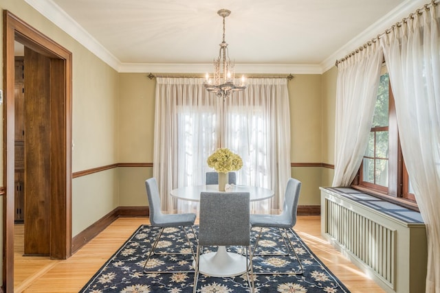 dining area featuring light hardwood / wood-style floors, a wealth of natural light, and a chandelier